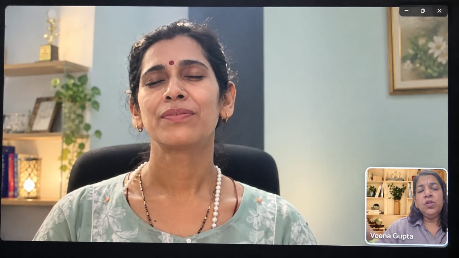 A confident woman delivering a speech to a seated audience in a conference room